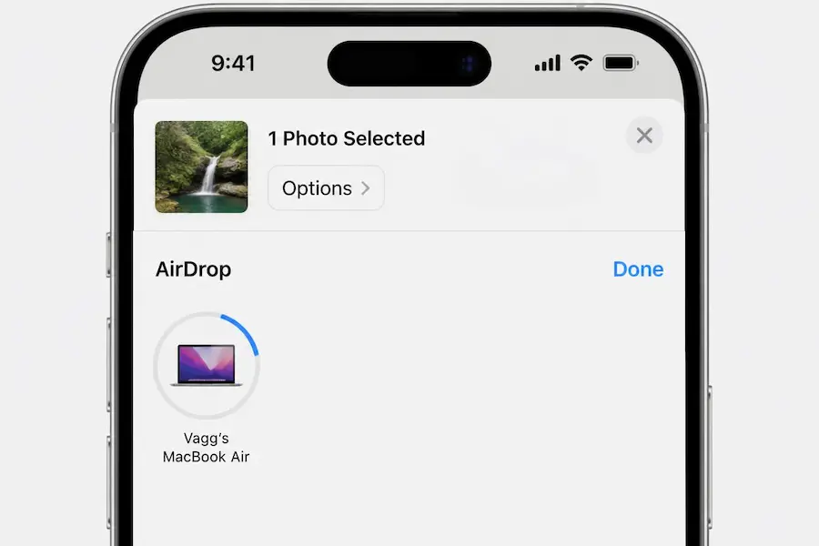 iPhone share sheet with AirDrop open and a MacBook shown as a recipient