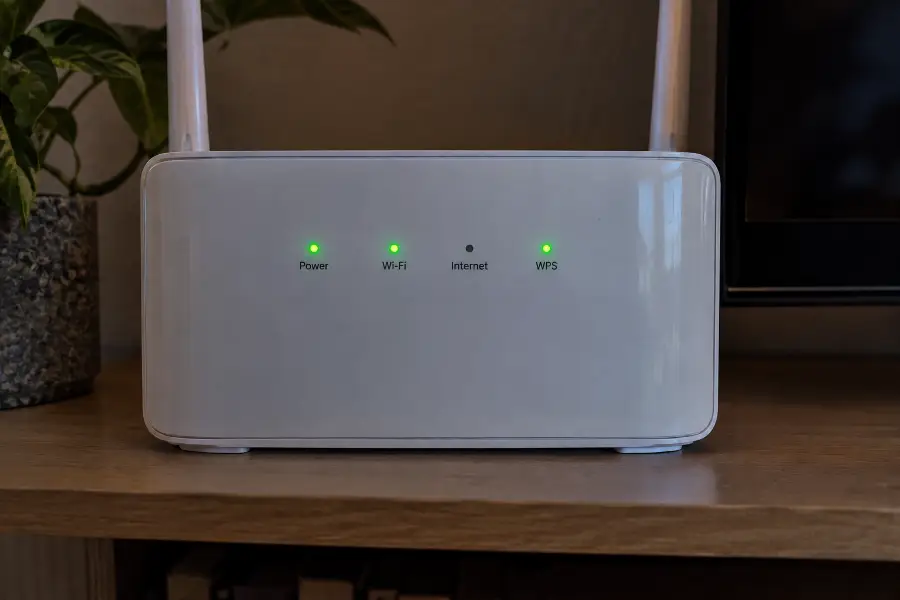 The front panel of a home router with the power, Wi-Fi and internet lights visible